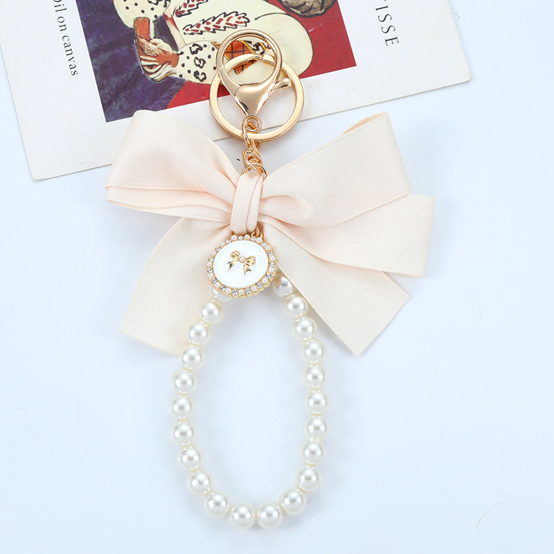 Porte-clés avec bracelet décoré de fausses perles