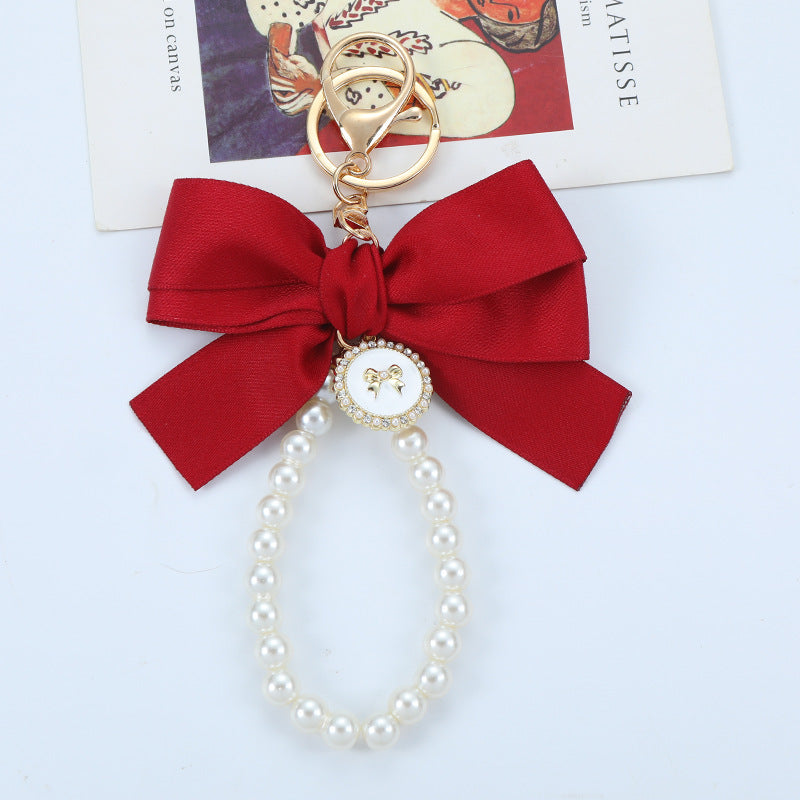 Porte-clés avec bracelet décoré de fausses perles