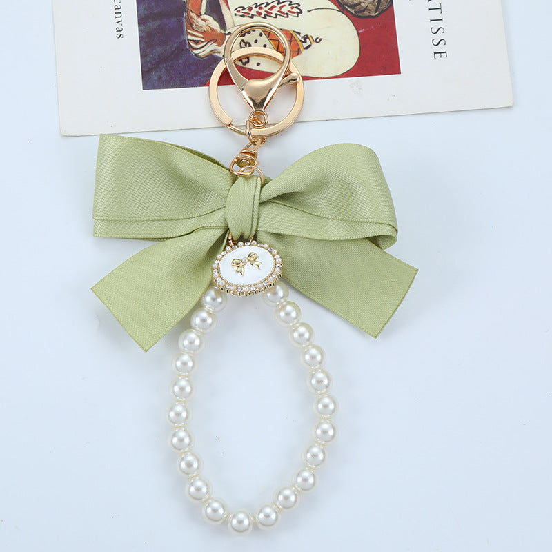 Porte-clés avec bracelet décoré de fausses perles