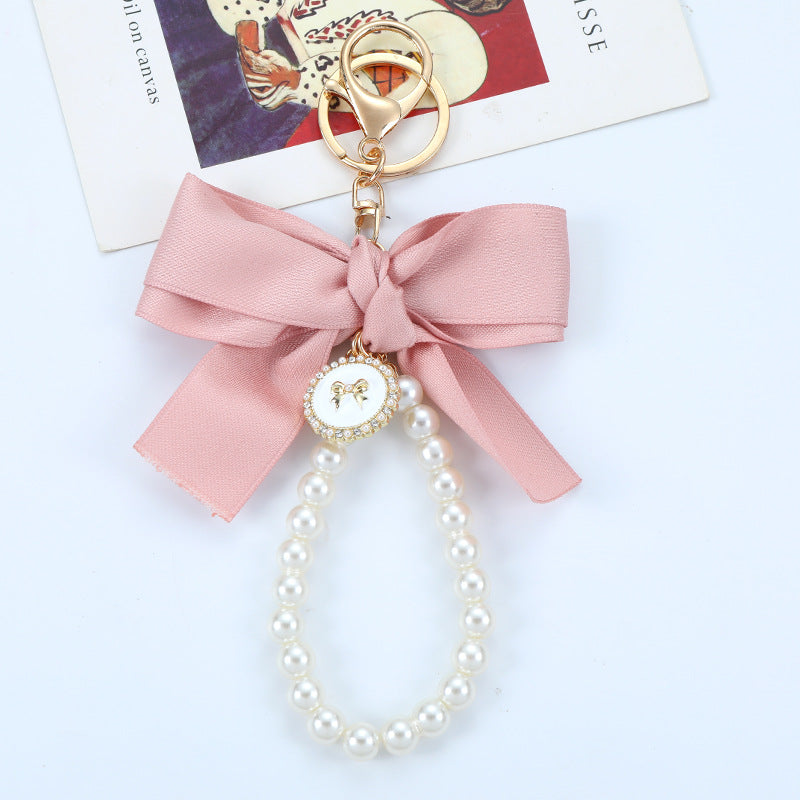 Porte-clés avec bracelet décoré de fausses perles